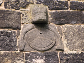 Ancient sun dial with pagan imagery